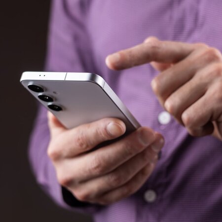 Close up image of man using his cell phone to look up information